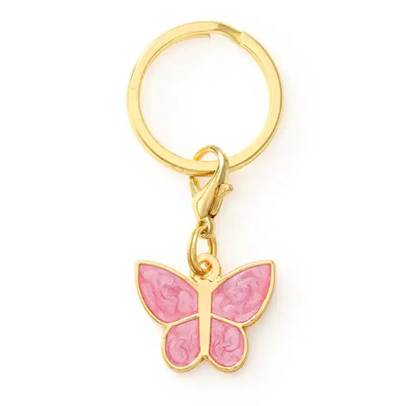 Pink butterfly dog collar charm on a gold ring