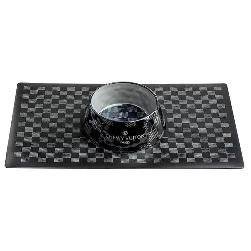 Black checkered Chewy Vuiton Pet Bowl shown on matching Chewy Vuiton Pet Placemat