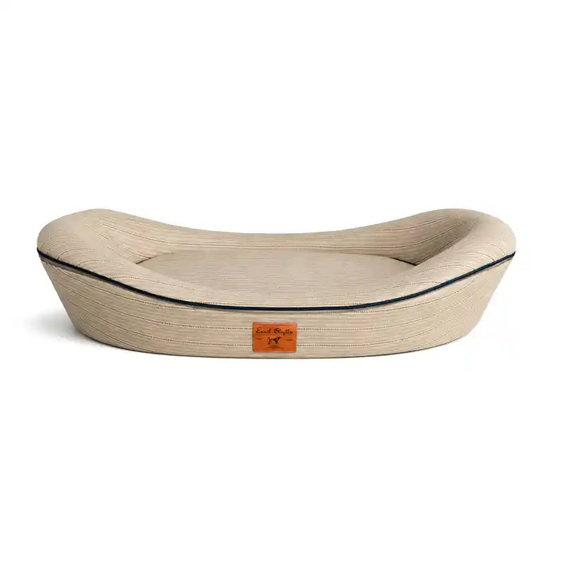 Beige textured pet bed with navy piping and brand label on a white background