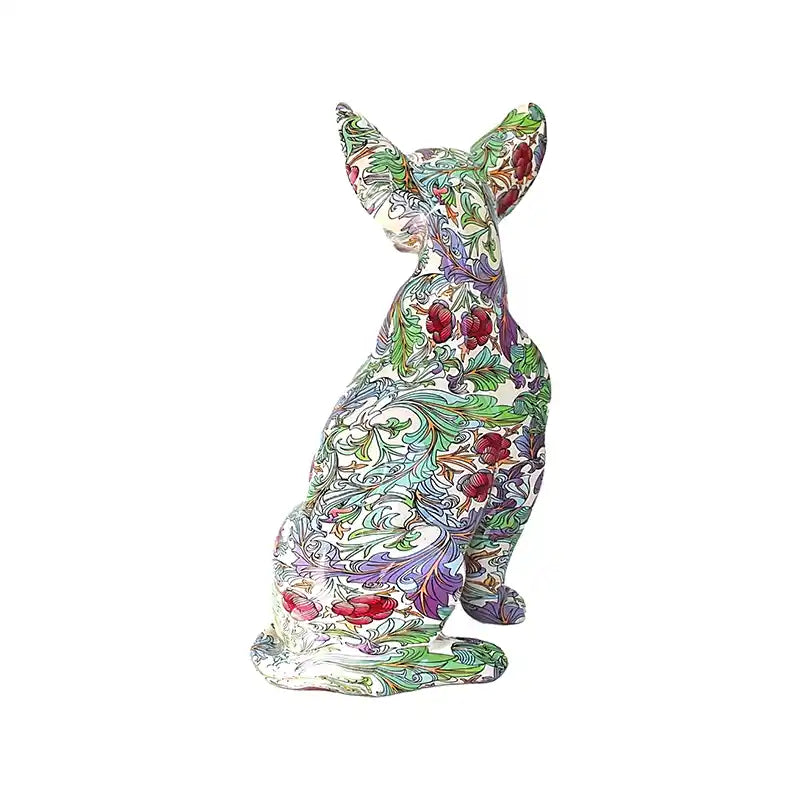 Back view of colorful floral-patterned chihuahua statue on a white background