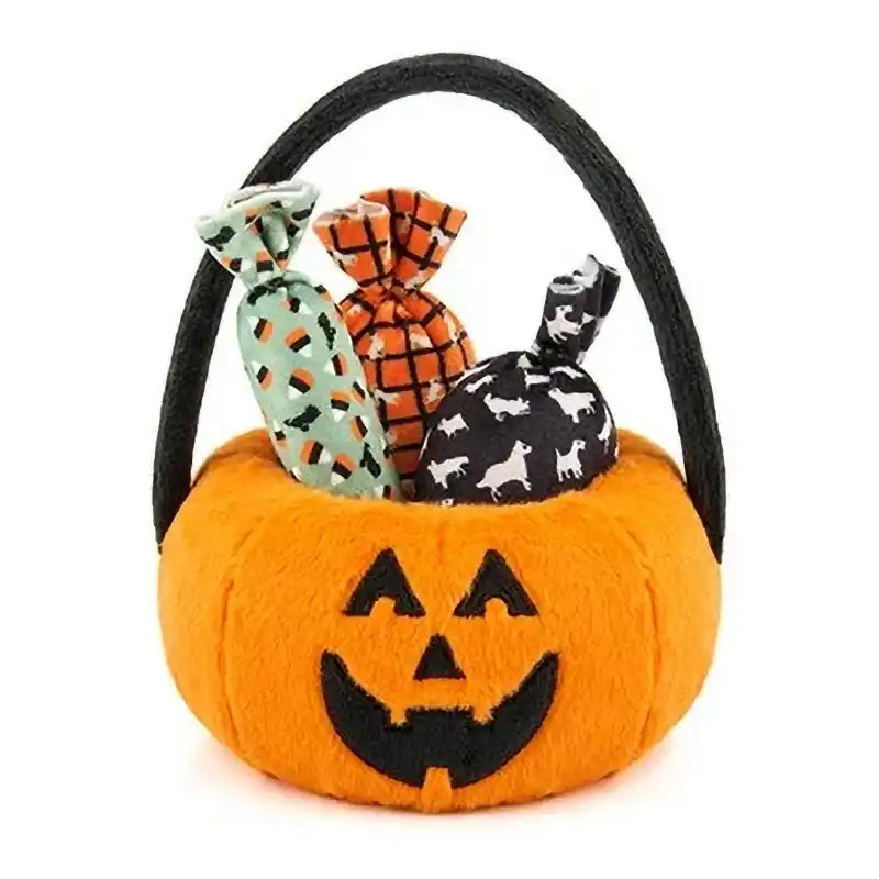 Plush pumpkin basket filled with three candy-shaped dog toys.