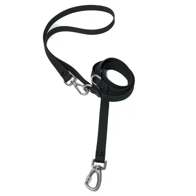 A black silicone coated webbing dog leash with a silver metal D-ring and a buckle, designed for hands-free crossbody wear.