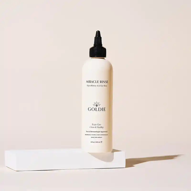 GOLDIE Miracle Dog Ear Rinse bottle on a light pink background