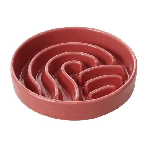 Pink ceramic wave slow feeder bowl on a white background