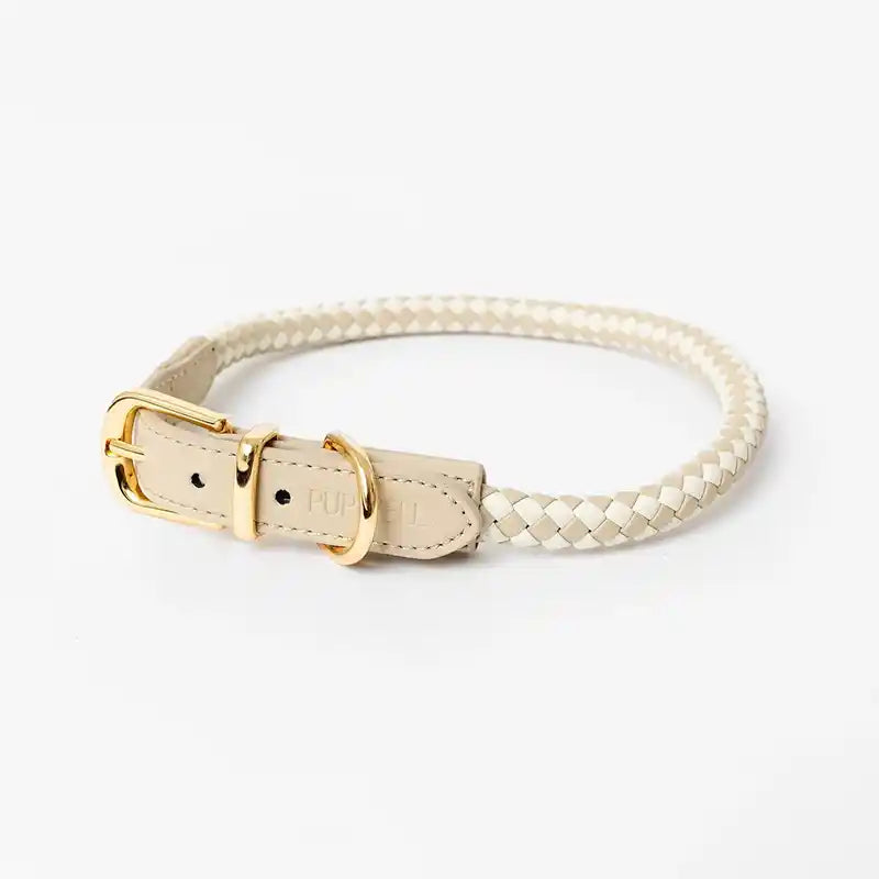 Cream and beige rolled, braided dog collar with a gold buckle on a white background