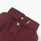 Wine dog polo shirt collar and placket with two buttons and embroidered player logo.