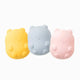 Yellow, blue, and pink silicon dog toys on white background