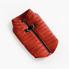 Flat lay view of red dog puffer vest.