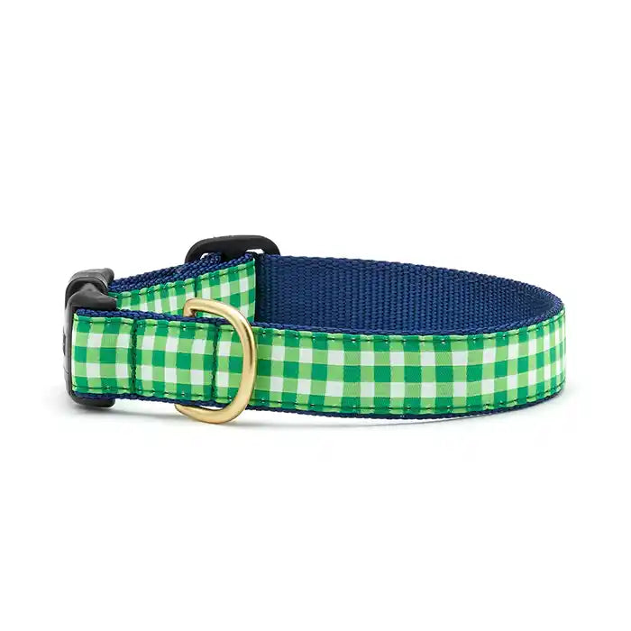 A lime green and white gingham dog collar with a navy blue interior and brass hardware.