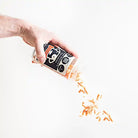 saint rocco's chicken sprinkles being poured out