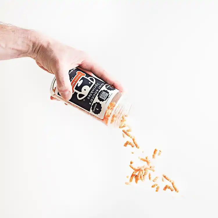 saint rocco's chicken sprinkles being poured out