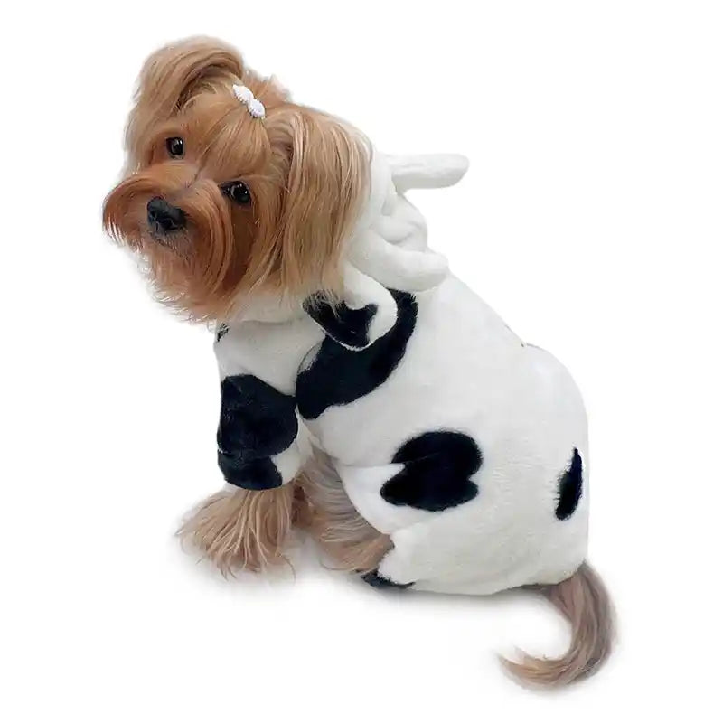 Dog wearing a cow print pajamas costume on a white background