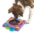 Dog interacting with dog puzzle feeder that's like a dj spin table