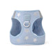 Front view of a light blue dog harness with a star pattern and a metal D-ring.