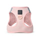 Front view of a light pink dog harness with a small black brand patch.