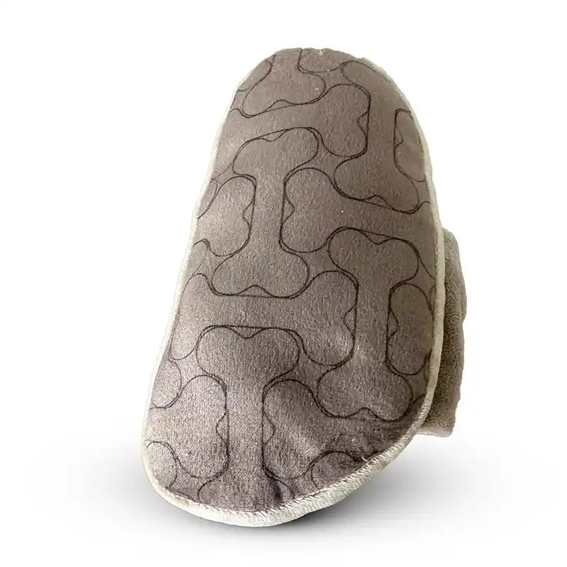 Underside of plush dog toy with bone pattern.