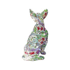 Back view of colorful floral-patterned chihuahua statue on a white background