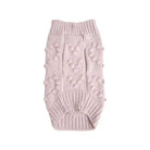 underside of pink knitted dog sweater adorned with bobbles shaped in hearts