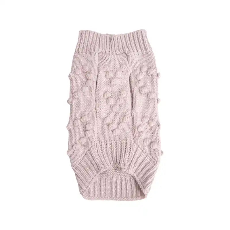 underside of pink knitted dog sweater adorned with bobbles shaped in hearts