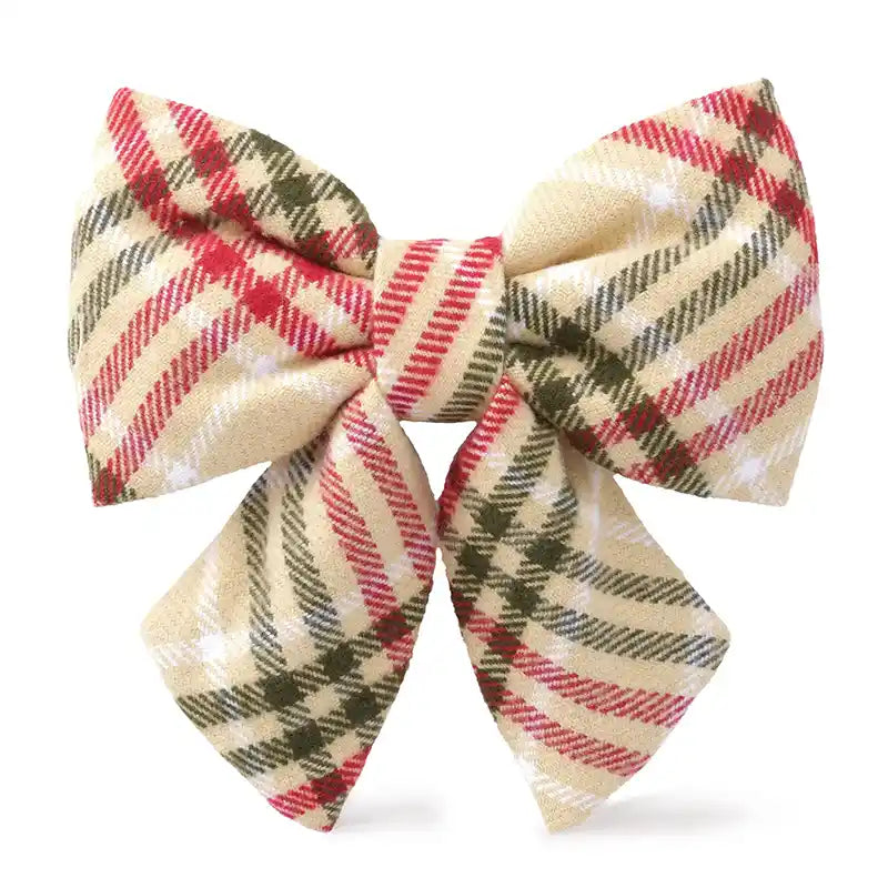 Plaid bow with red, green, and beige colors on a white background