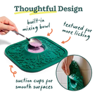Green pet lick mat with built-in mixing bowl and suction cups, labeled 'Thoughtful Design'.