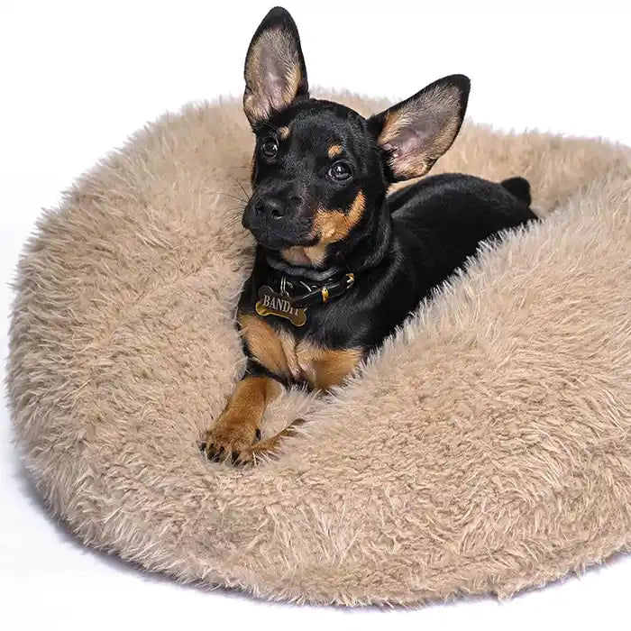 A beige, fluffy dog bed made of recycled fiber.