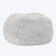 A grey, fluffy dog bed made of recycled fiber, designed to feel like a cloud.