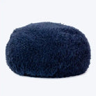 A navy, fluffy dog bed made of recycled fiber, designed to feel like a cloud.