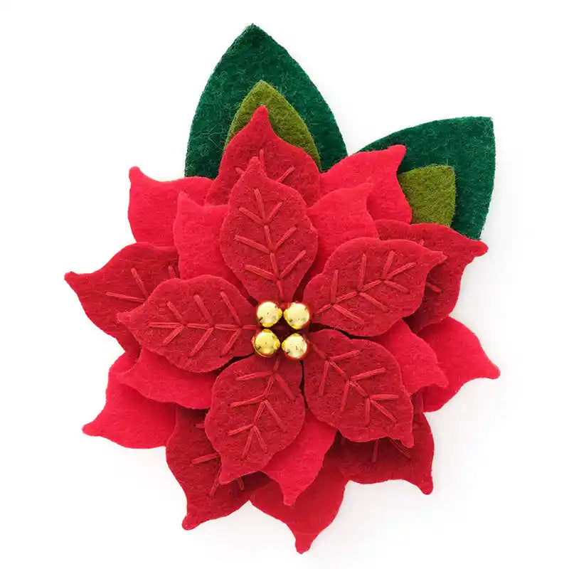 Red felt poinsettia dog flower collar with green leaves on a white background