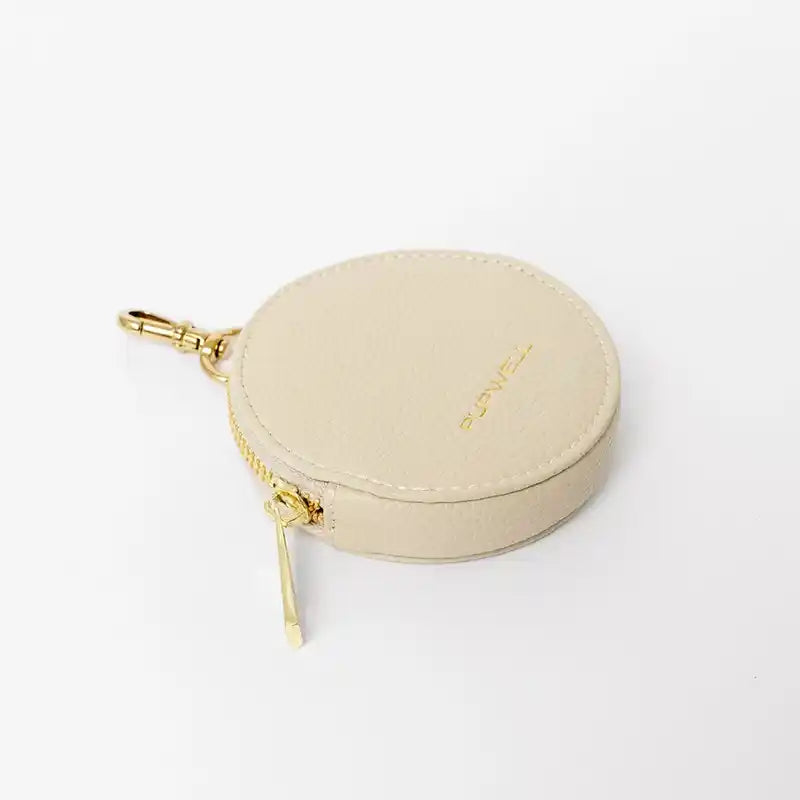 Beige treat pouch with gold zipper on a white background