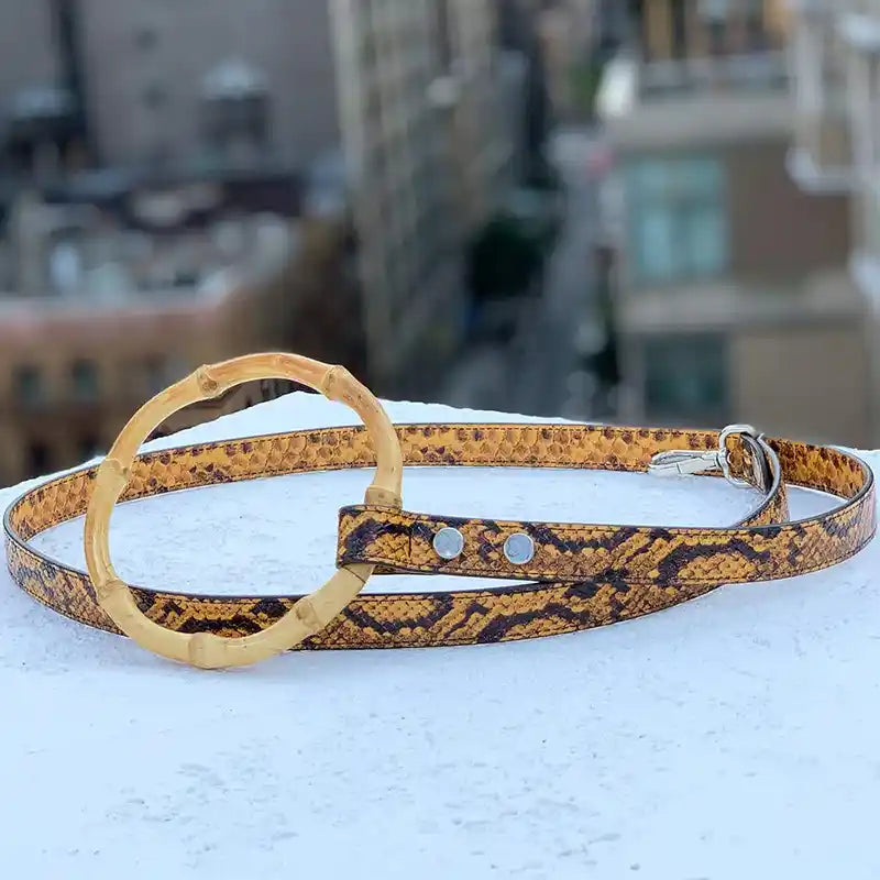 Dog leash with embossed python pattern and a round faux circular bamboo handle 