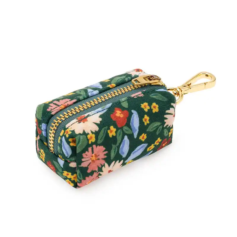 Floral-patterned poo bag holder with a gold zipper on a white background