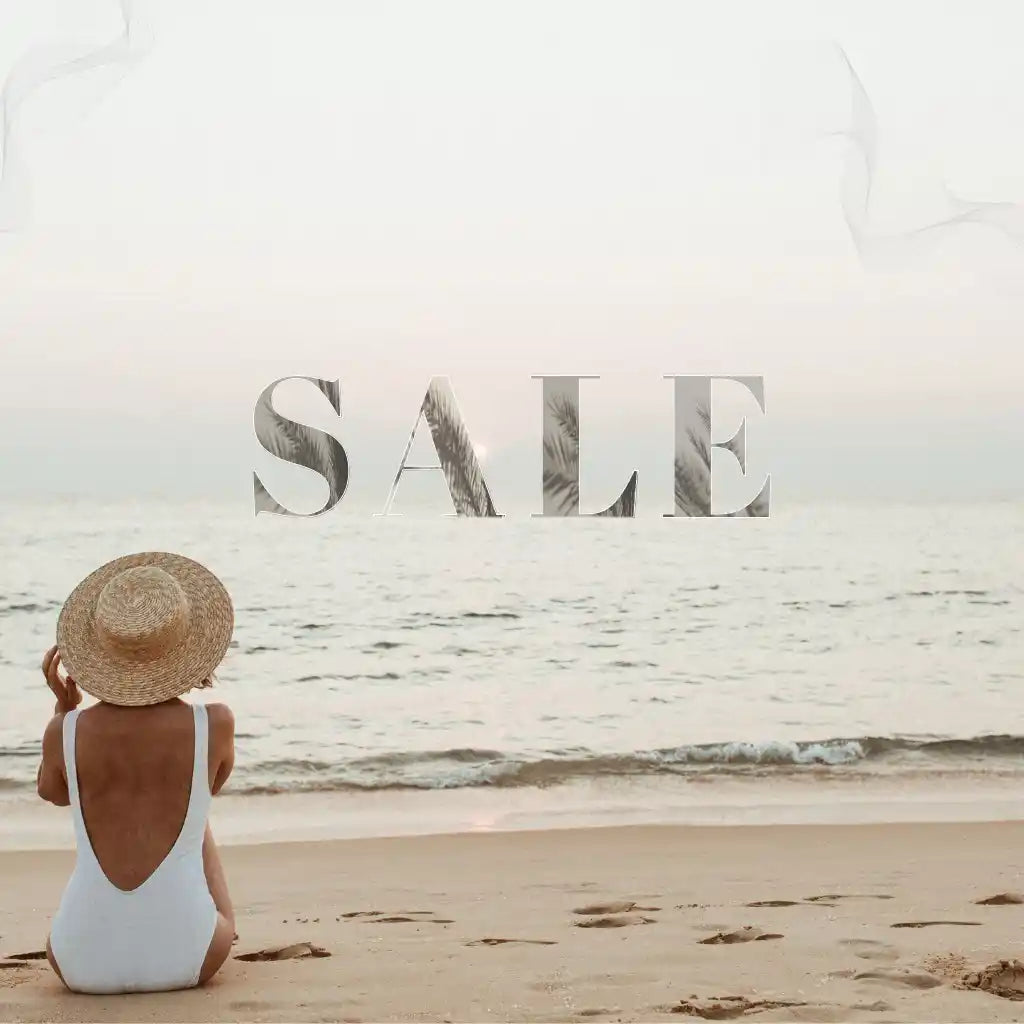 Person in a swimsuit and hat sitting on a beach with 'SALE' text overlay.