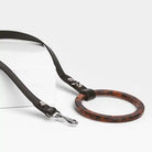 Dog leash with tortoiseshell ring on a white background
