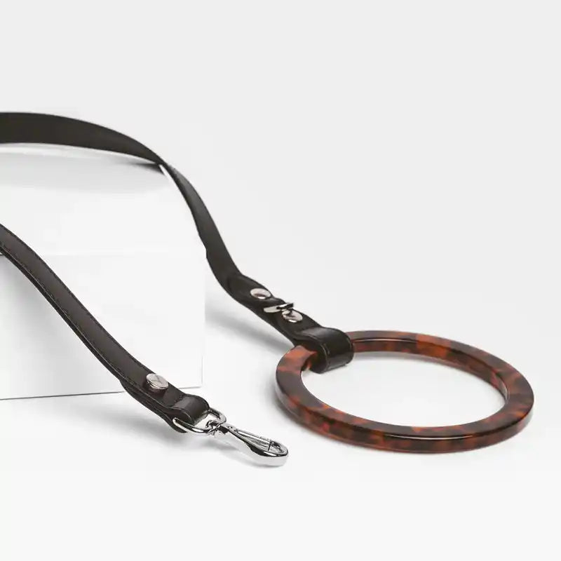Dog leash with tortoiseshell ring on a white background