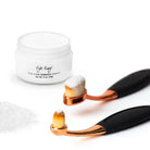 Eye Envy tear stain powder jar with two applicator brushes on a white background