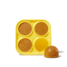 Yellow silicone mold with 4 frozen treats - 3 inside the cavities and 1 popped out to show dome shape