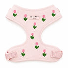 Pink dog harness with pink embroidered tulips on a white background