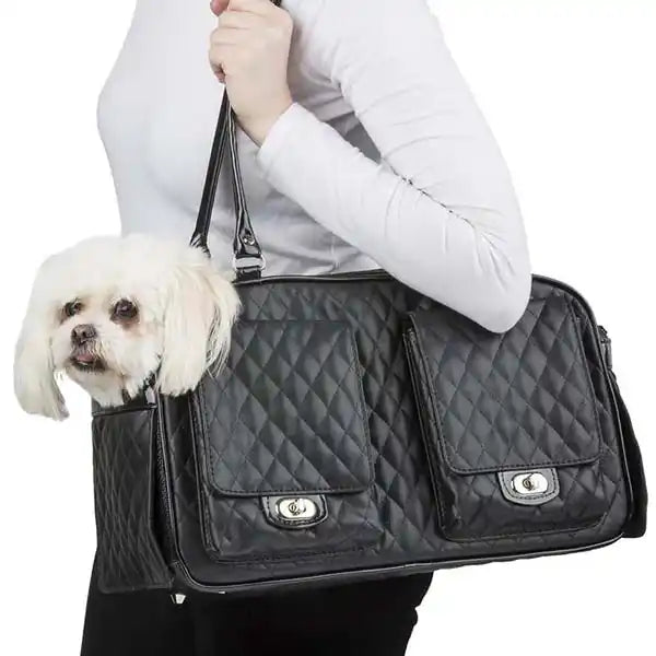 dog being carried in a luxury black quilted pet carrier